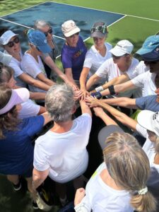 pickleball group hands in